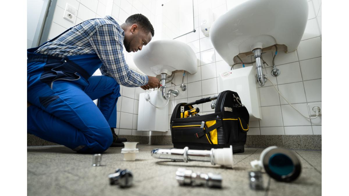 Plumber fixing pipes